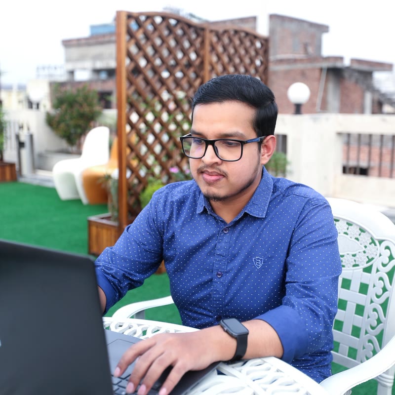 Md. Musfiqur Rahaman, Full Stack Software Engineer, working on a laptop